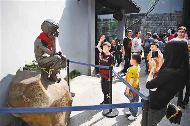 白公馆景区,一名孩子向小萝卜头雕像敬礼。首席记者 谢智强 摄 图:新华网
